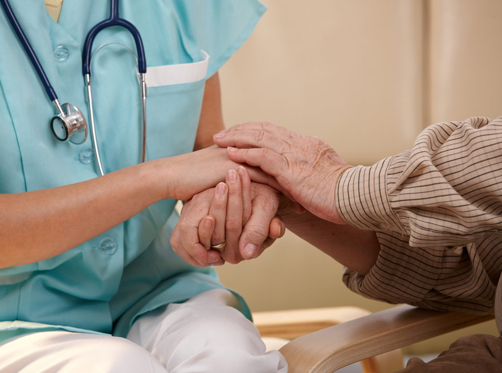 Nurse consoling patient with mental disability - estate planning concept