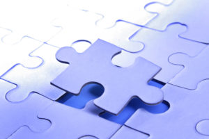 Puzzle piece separating from puzzle - metaphor for partial disclaimers