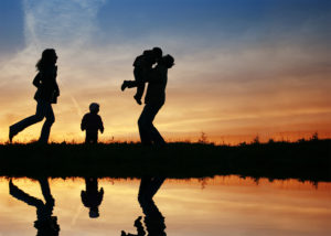 Silhouette of family by lake - estate planning concept
